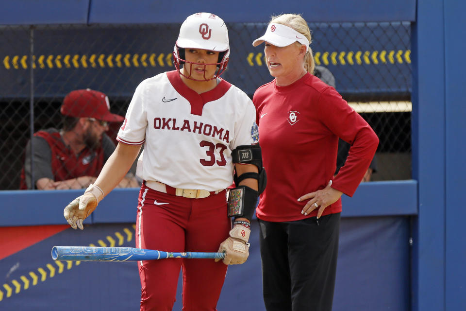 Oklahoma coach Patty Gasso, right, talks to Alyssa Brito during the sixth inning of the team's NCAA softball Women's College World Series game against Stanford on Thursday, June 1, 2023, in Oklahoma City. (AP Photo/Nate Billings)