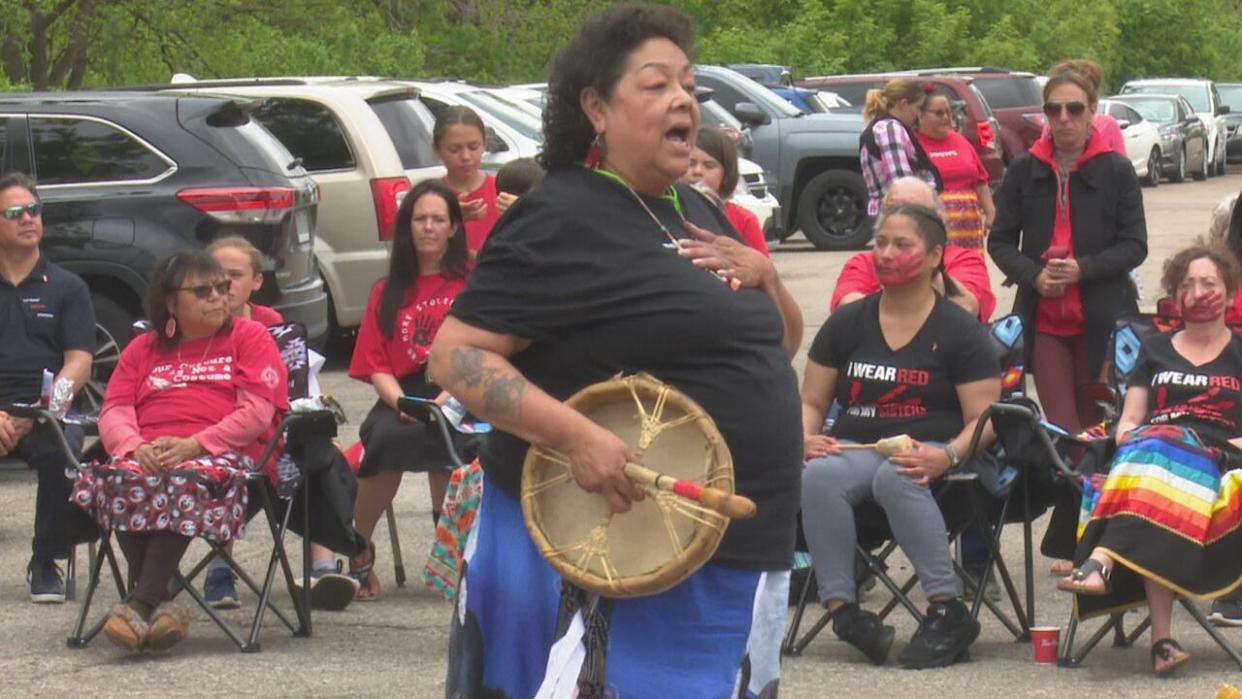 Tracey Whiteye, executive director of the Can-Am Indian Friendship Centre in Windsor, leads a ceremony on Red Dress Day. (Dalson Chen/CBC - image credit)