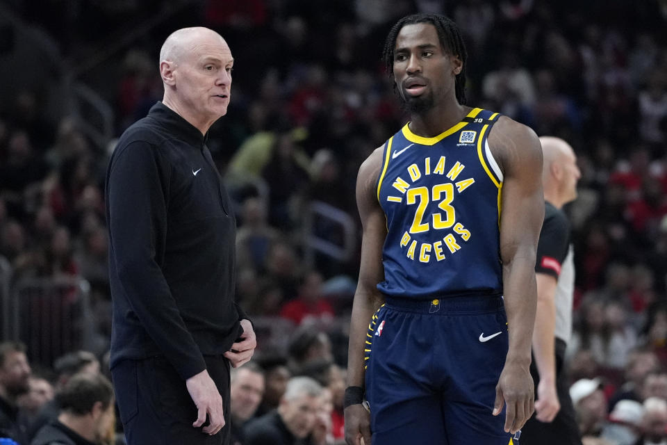 Indiana Pacers head coach Rick Carlisle, left, talks to forward Aaron Nesmith during the first half of an NBA basketball game against the Chicago Bulls in Chicago, Wednesday, March 27, 2024. (AP Photo/Nam Y. Huh)