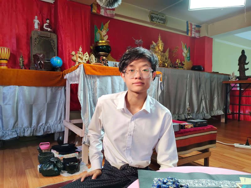 Hein Min Aung, an astrologer, sits in his home, where he receives guests to tell their fortunes, in Yangon