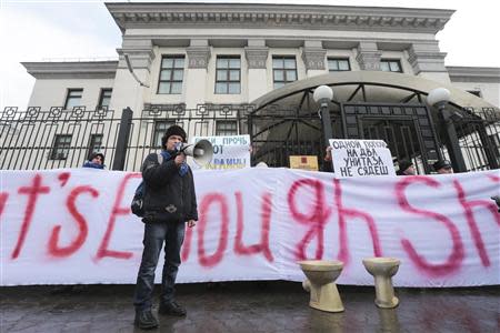 Activists of the "Democratic Alliance" movement stage a performance during a protest rally in front of the Russian embassy in Kiev, February 7, 2014. REUTERS/Konstantin Chernichkin