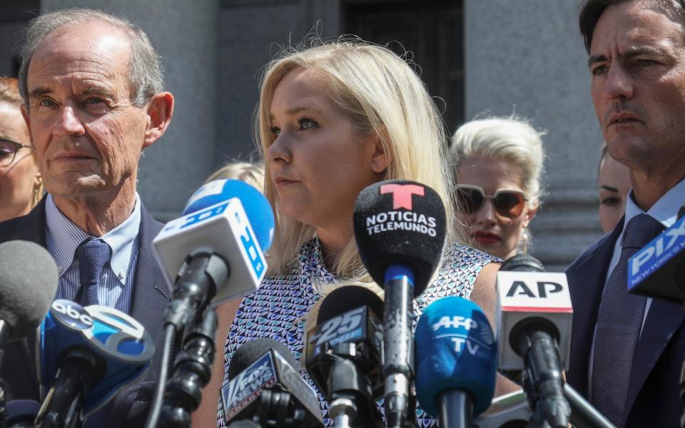 Ms Giuffre, center, who says she was trafficked by sex offender Jeffrey Epstein, holds a news conference in New York - Bebeto Matthews/AP