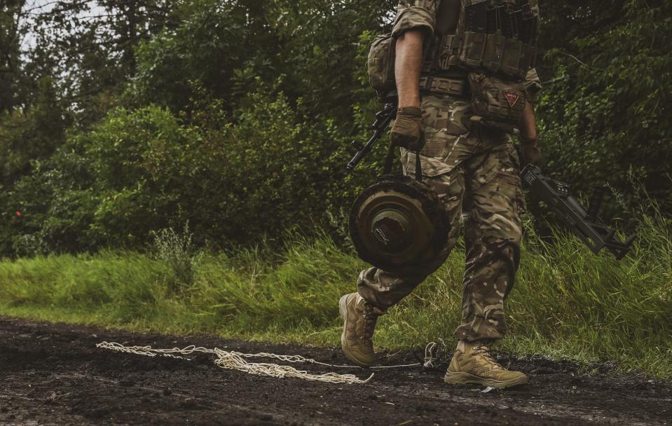 A shot of the lower half of a marine carrying a mine.