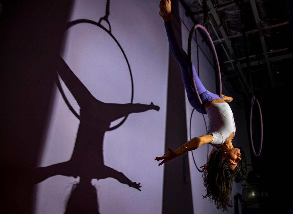 Instructor Rubi Rymenmy inverts herself in a suspended hoop at Art Flying Aerial in Palm Desert, Calif., Friday, Dec. 9, 2022. 