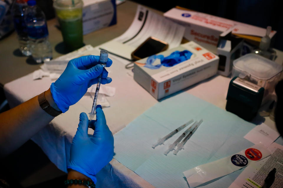 A healthcare worker prepares a dose of the Pfizer-BioNTech vaccine 