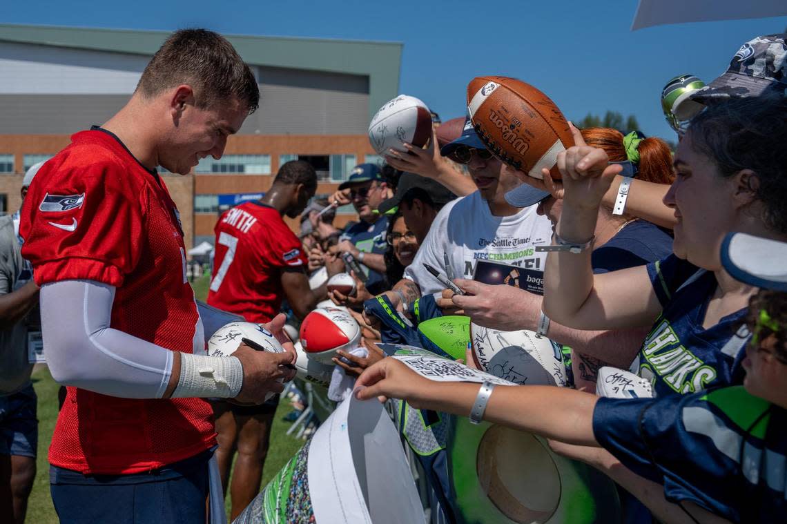 Seattle Seahawks quarterback Drew Lock signs a fan’s football after the second day of Seahawks training camp at the Virginia Mason Athletic Center in Renton, Wash. on July 28, 2022.