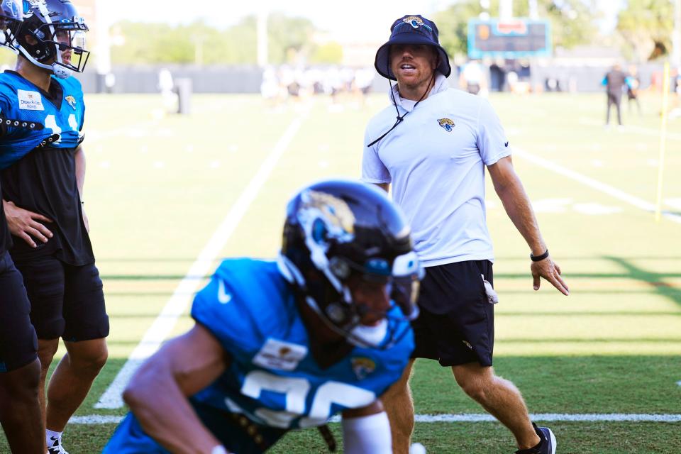 Jaguars receivers coach Chad Hall looks on as players run ladder drills Monday in training camp at Miller Electric Center.