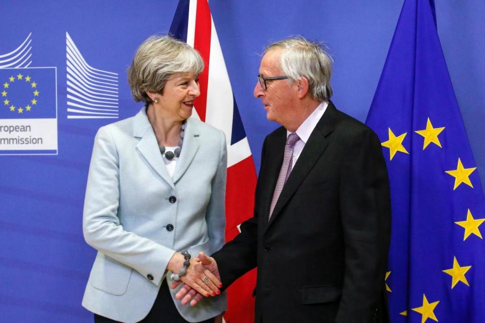 Theresa May with Jean-Claude Juncker on December 8, after agreeing first stage talks had resulted in a deal. (Bloomberg via Getty Images)