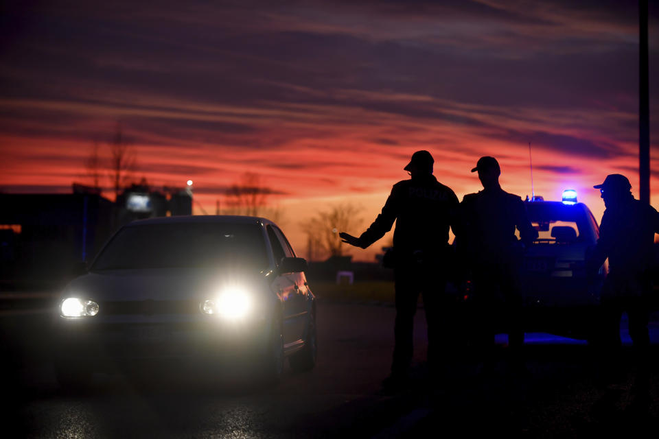 Police stops cars trying to enter or leave the cordoned area in Casalpusterlengo, Northern Italy, Sunday, Feb. 23, 2020. A dozen Italian towns saw daily life disrupted after the deaths of two people infected with the virus from China and a pair of case clusters without direct links to the outbreak abroad. A rapid spike in infections prompted authorities in the northern Lombardy and Veneto regions to close schools, businesses and restaurants and to cancel sporting events and Masses. (Claudio Furlan/LaPresse via AP)