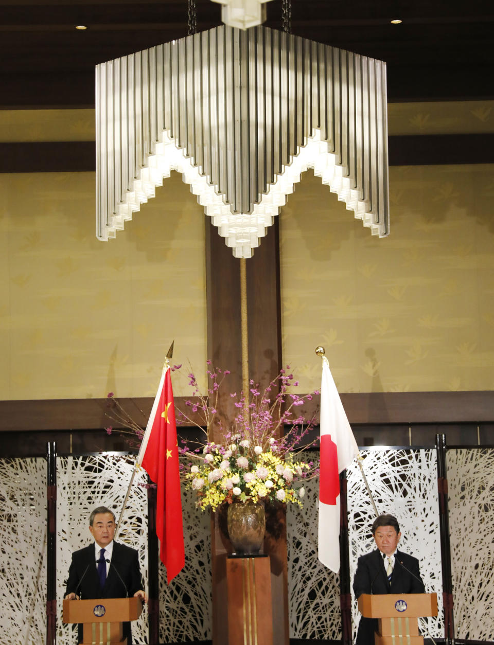 China' Foreign Minister Wang Yi, left, and his Japanese counterpart Toshimitsu Motegi participate in a press briefing in Tokyo on Tuesday, Nov. 24, 2020. Wang met Motegi on Tuesday to discuss ways to revive their pandemic-hit economies as well as regional concerns over China’s growing influence. (Issei Kato/Pool Photo via AP)