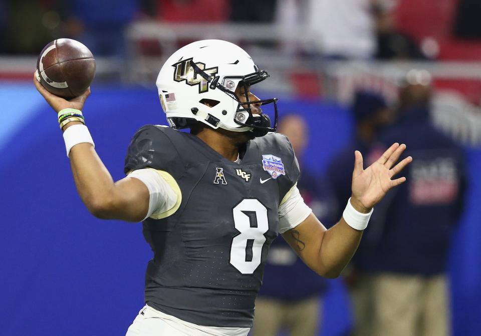 UCF quarterback Darriel Mack Jr. (8) warms up prior to the Fiesta Bowl NCAA college football game against LSU Tuesday, Jan. 1, 2019, in Glendale, Ariz. (AP Photo/Ross D. Franklin)