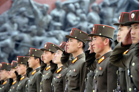 North Korean soldiers salute bronze statues (not pictured) of North Korea's late founder Kim Il-sung and late leader Kim Jong Il at Mansudae in Pyongyang, in this photo released by Kyodo April 25, 2017, to mark the 85th anniversary of the founding of the Korean People's Army. Mandatory credit Kyodo/via REUTERS