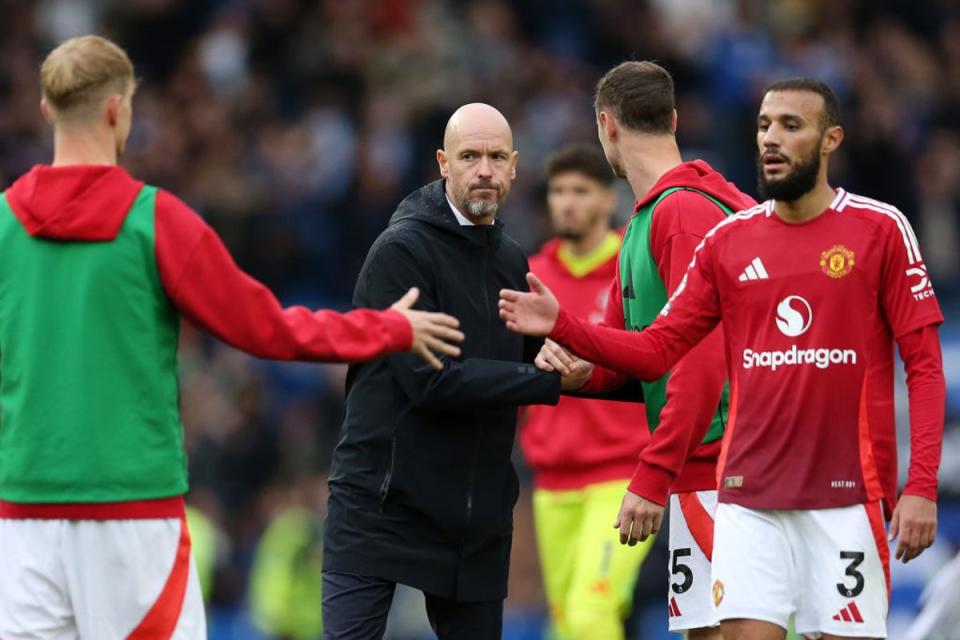 Erik ten Hag shakes hands with his team following their defeat to Brighton (Getty)