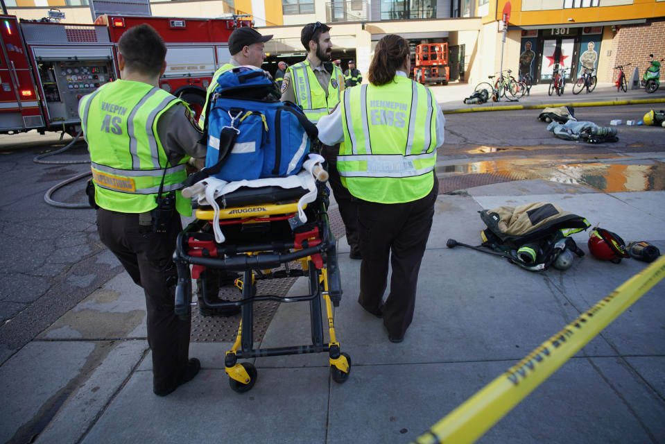 Members of an EMT team stand by as a Dinkytown apartment building was being evacuated after a report of a hazardous materials incident in Minneapolis on Tuesday, May 7, 2019. Fire crews are evacuating the residential building near the University of Minnesota because of a suspected hazardous materials incident. (Richard Tsong-Taatarii/Star Tribune via AP)