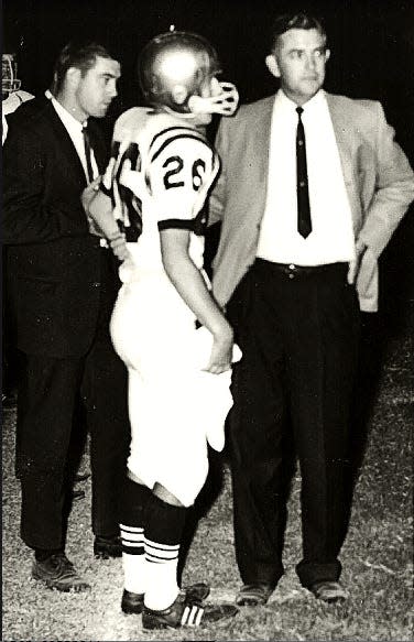 Bartlesville Sooner High School head football coach Bill Holbrook, right, visits with one of his players during game action in the later 1960's or 1970's.