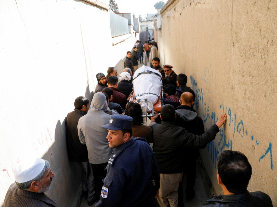 <p>Relatives carry the body of one of female judges shot dead by unknown gunmen in Kabul</p> (REUTERS)