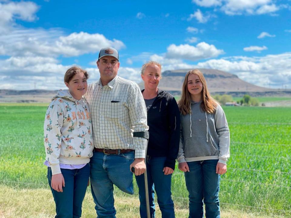 Klamath Basin farmers Ben and Erika DuVal and their daughters, Helena and Hannah, stand last week beside a field irrigated with well water. Faced with a crippling drought, Ben DuVal is worried about outside agitators using “this crisis in our community and use it as a soapbox to push their agenda.”