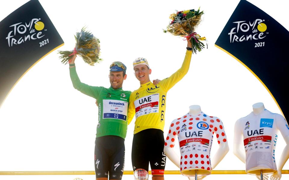 Mark Cavendish of The United Kingdom and Team Deceuninck - Quick-Step Green Points Jersey & Tadej PogaÄar of Slovenia and UAE-Team Emirates Yellow Leader Jersey and Polka Dot Mountain Jersey celebrate at podium during the 108th Tour de France 2021, Stage 21 a 108,4km stage from Chatou to Paris Champs-Ã‰lysÃ©es / @LeTour / #TDF2021 / on July 18, 2021 in Paris - GETTY IMAGES