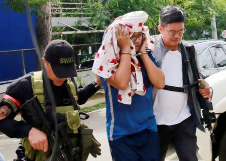 FILE PHOTO: Police escort one of the Maute brothers, Mohammad Noaim Maute, alias Abu Jahid, who was arrested at a checkpoint, in Cagayan De Oro city, Philippines June 15, 2017. REUTERS/Froilan Gallardo/File Photo