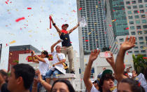 MIAMI, FL - JUNE 25: Fans cheer as Miami Heat players pass by in a victory parade through the streets during a celebration for the 2012 NBA Champion Miami Heat on June 25, 2012 in Miami, Florida. The Heat beat the Oklahoma Thunder to win the NBA title. (Photo by Joe Raedle/Getty Images)