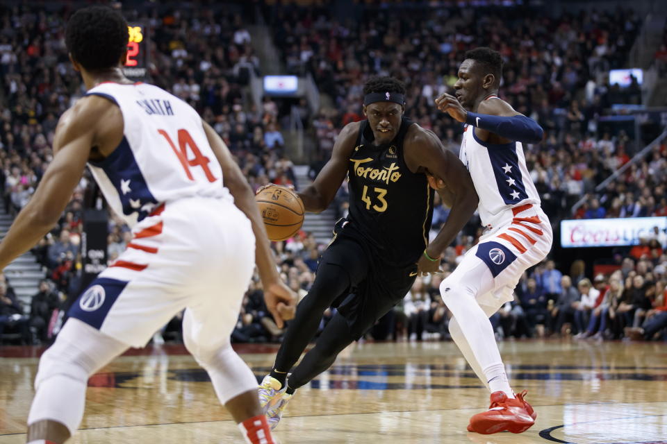 CORRECTS PLAYER AT RIGHT TO ISAAC BONGA, INSTEAD OF THOMAS BRYANT - Toronto Raptors forward Pascal Siakam (43) drives against Washington Wizards center Isaac Bonga, right, during the first half of an NBA basketball game Friday, Jan. 17, 2020, in Toronto. (Cole Burston/The Canadian Press via AP)