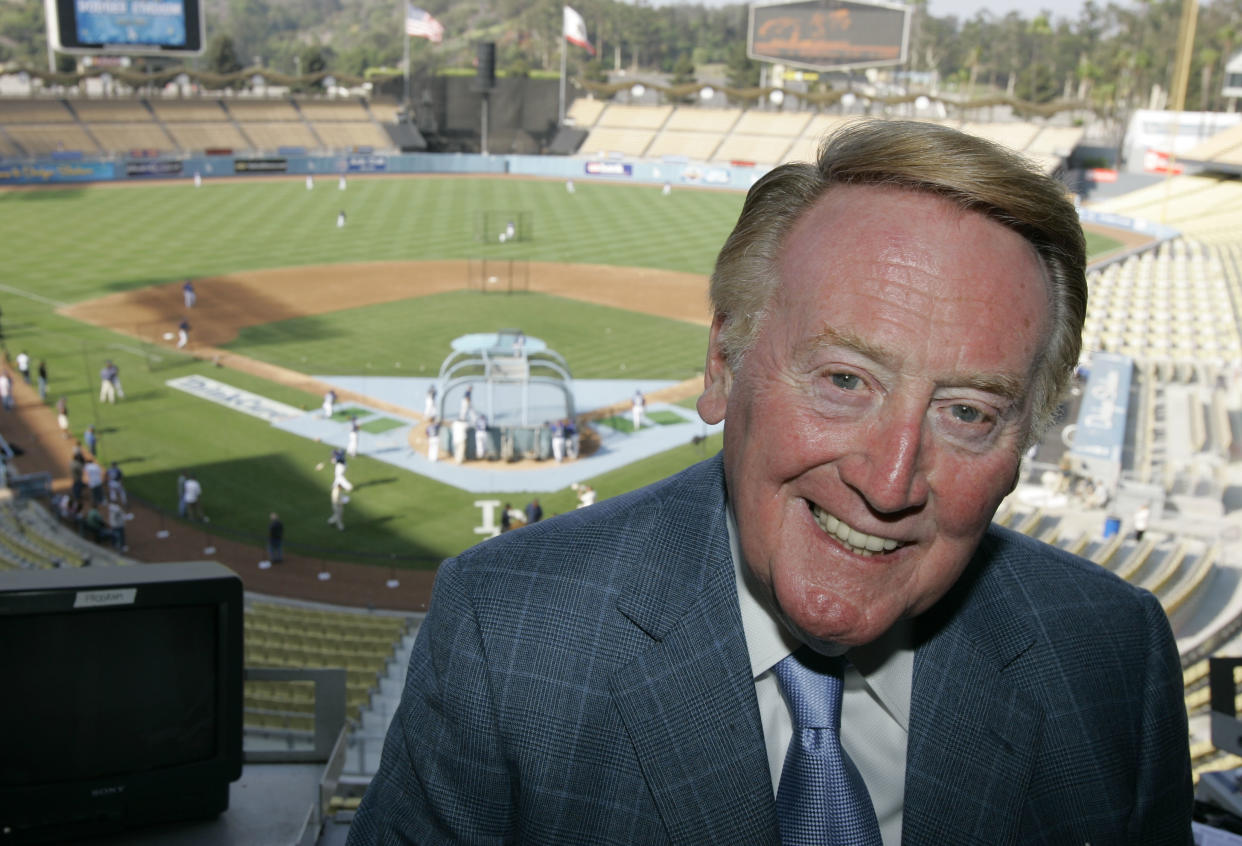 Vin Scully is shown the pressbox of Dodger Stadium before the start of their baseball game against the San Francisco Giants and the Dodgers, in Los Angeles, Wednesday, Aug. 1, 2007. (AP Photo/Mark J. Terrill)