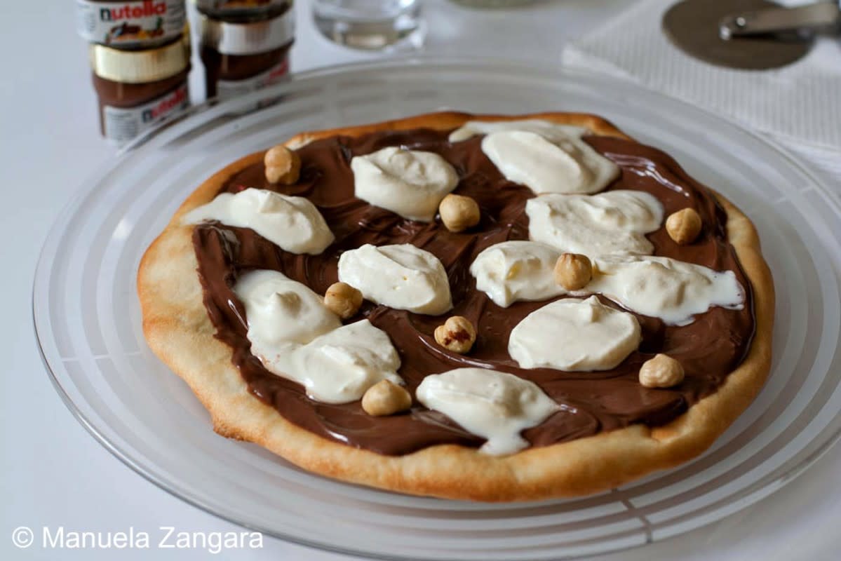 <p>Manu’s Menu</p><p>Nutella pizza has a pizza base, topped with Nutella, whipped cream and toasted hazelnuts. </p><p><strong>Get the recipe: <a href="http://www.manusmenu.com/nutella-pizza" rel="nofollow noopener" target="_blank" data-ylk="slk:Nutella Pizza;elm:context_link;itc:0;sec:content-canvas" class="link rapid-noclick-resp">Nutella Pizza</a></strong></p>