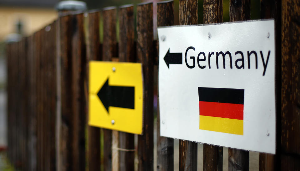 FILE - In this Thursday, Oct. 15, 2015 file photo signs are attached on a fence at the border between Austria and Germany in Wegscheid near Passau, Germany. Germany's population has contracted slightly for the first time in nearly a decade because immigration shrank as a result of the coronavirus pandemic, official data showed Tuesday. (AP Photo/Matthias Schrader, file)