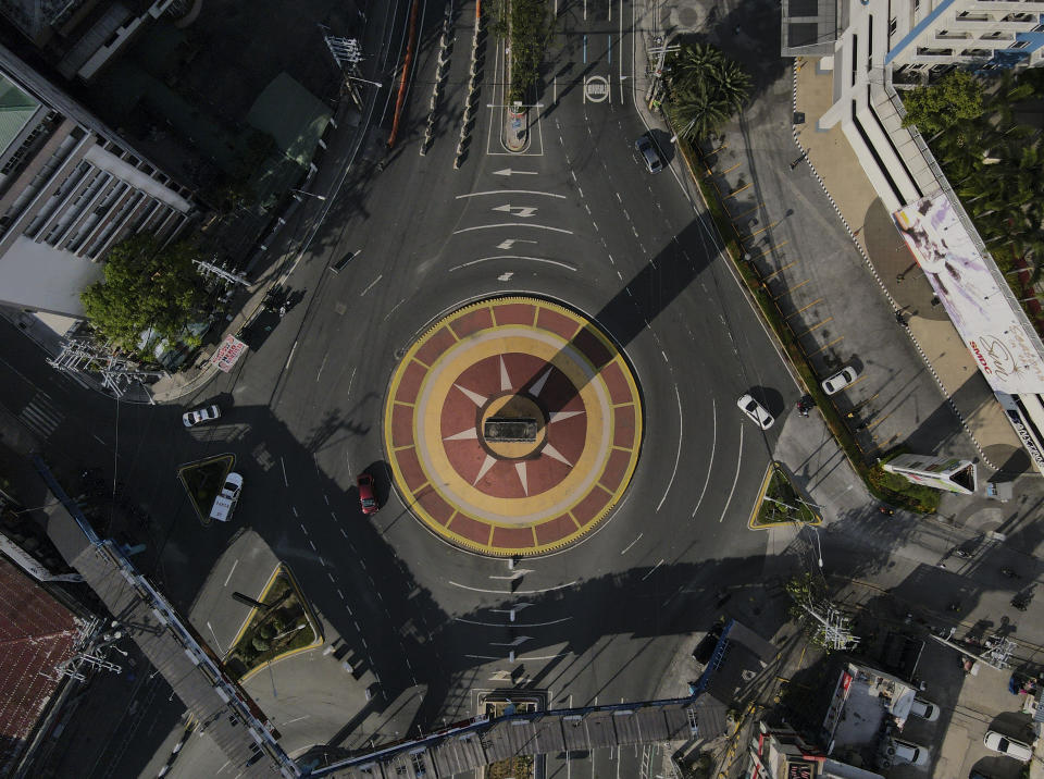 An almost empty Welcome Rotonda roundabout is seen as the government implements a strict lockdown to prevent the spread of the coronavirus on Good Friday, April 2, 2021 in Manila, Philippines. Filipinos marked Jesus Christ's crucifixion Friday in one of the most solemn holidays in Asia's largest Catholic nation which combined with a weeklong coronavirus lockdown to empty Manila's streets of crowds and heavy traffic jams. Major highways and roads were eerily quiet on Good Friday and churches were deserted too after religious gatherings were prohibited in metropolitan Manila and four outlying provinces. (AP Photo/Aaron Favila)