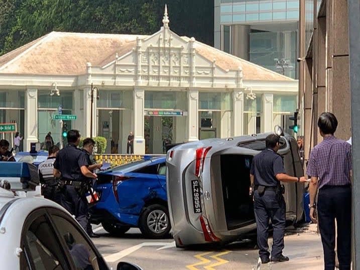 An accident between a taxi and a car at AIA Tower, near Raffles Place MRT Station. (PHOTO: Roads.SG/Facebook)