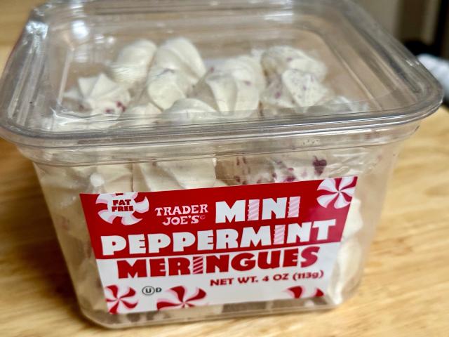 Clear, red, and white container of peppermint meringues from trader joe's