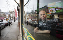 Paul Boutros, owner of East Side Pockets, a small restaurant near Brown University, looks out onto an empty street since students were sent home two weeks ago, Wednesday, March 25, 2020, in Providence, R.I. "He's not being realistic. How can you open if the cases are climbing day after day?" asked Boutros on Trump's call to restart the economy by mid-April. "You go to Walmart, you don't know if the people around you, if they have the virus. People come to our restaurant. I don't know if they have the virus." (AP Photo/David Goldman)