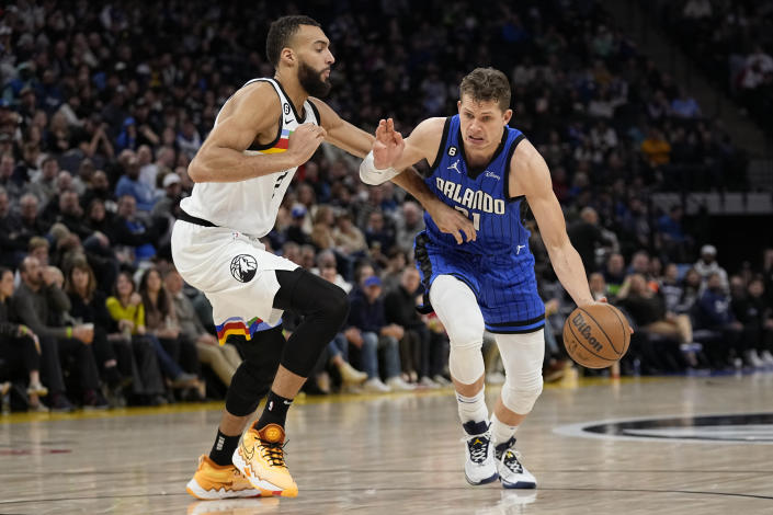 Orlando Magic center Moritz Wagner, right, works towards the basket against Minnesota Timberwolves center Rudy Gobert during the second half of an NBA basketball game, Friday, Feb. 3, 2023, in Minneapolis. (AP Photo/Abbie Parr)