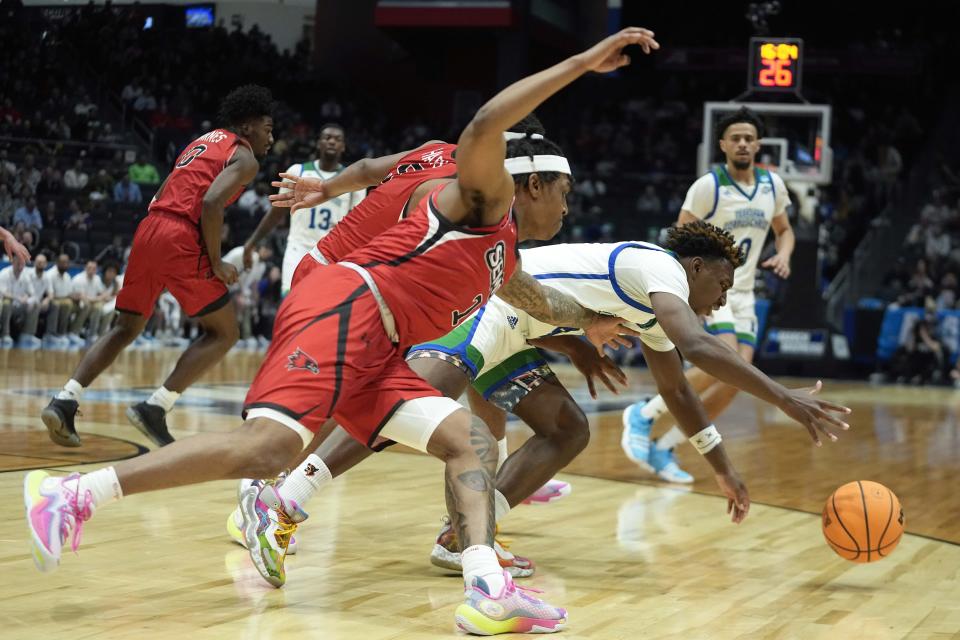 Texas A&M Corpus Christi's Jalen Jackson, right, and Southeast Missouri State's Phillip Russell, left, battle for a loose ball during the first half of a First Four college basketball game in the NCAA men's basketball tournament, Tuesday, March 14, 2023, in Dayton, Ohio. (AP Photo/Darron Cummings)