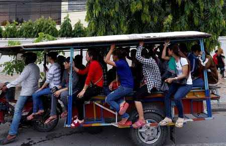 Garment workers travel back home as they leave a factory after work, on the outskirts of Phnom Penh, Cambodia, October 16, 2018. Picture taken October 16, 2018. REUTERS/Samrang Pring