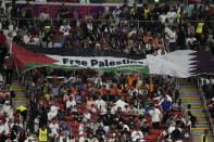 Supporters show a flag reading "Free Palestine" on the tribune during the World Cup group A soccer match between the Netherlands and Qatar, at the Al Bayt Stadium in Al Khor , Qatar, Tuesday, Nov. 29, 2022. (AP Photo/Moises Castillo)