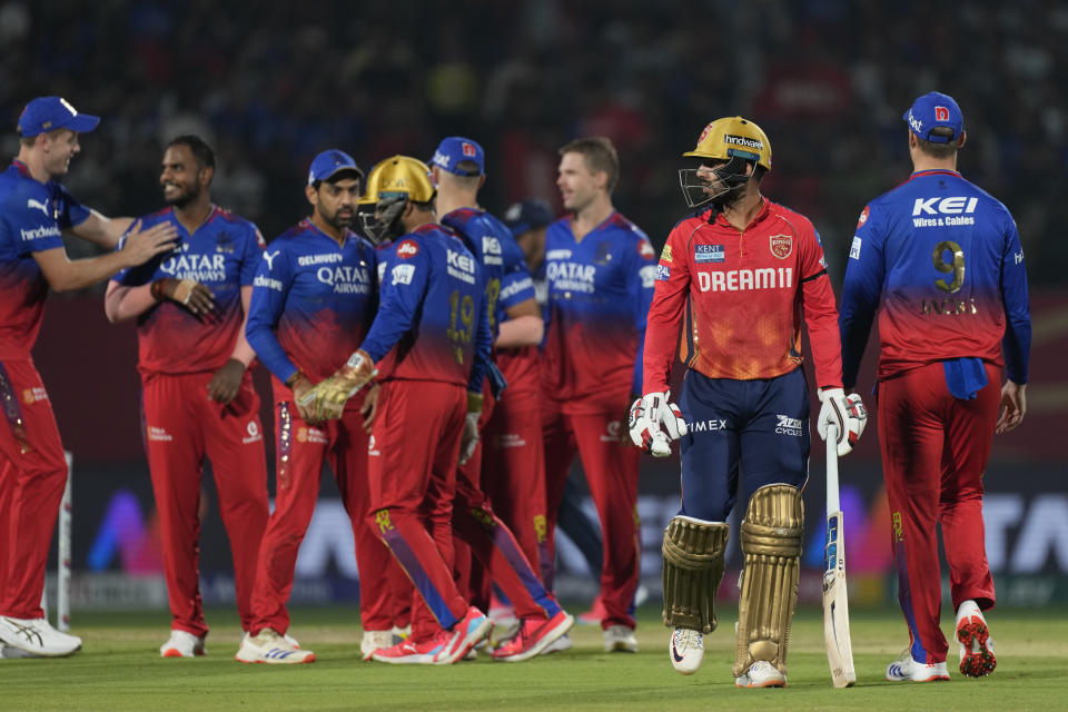 Punjab Kings' Jitesh Sharma, second right, walks off the field after losing his wicket during the Indian Premier League cricket match between Punjab Kings and Royal Challengers Bengaluru in Dharamshala, India, Thursday, May 9, 2024. (AP Photo /Ashwini Bhatia)