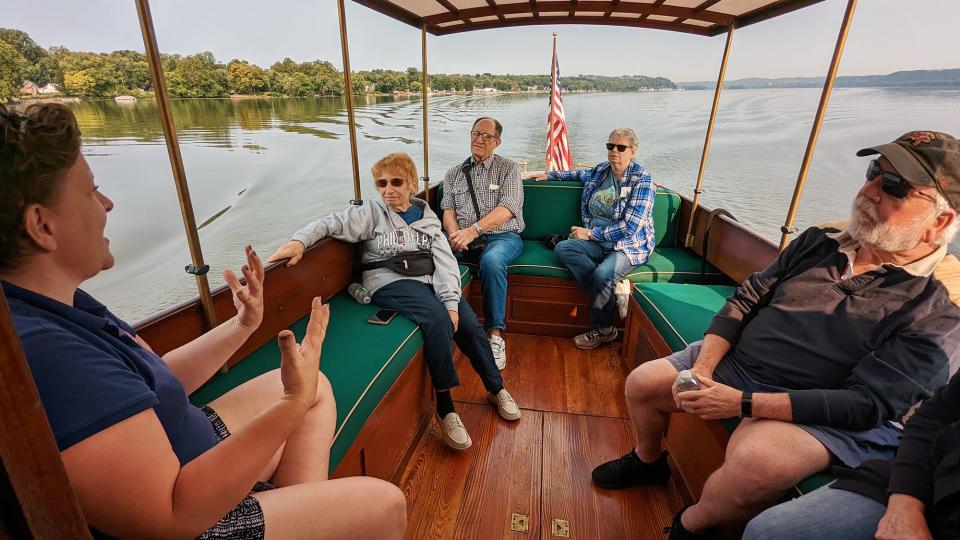 A guide tells a small group of visitors the history of the 110-year-old boat as it glides along the Susquehanna River on September 16, 2022.