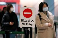 Passengers wearing masks are seen at Hongqiao International Airport in Shanghai