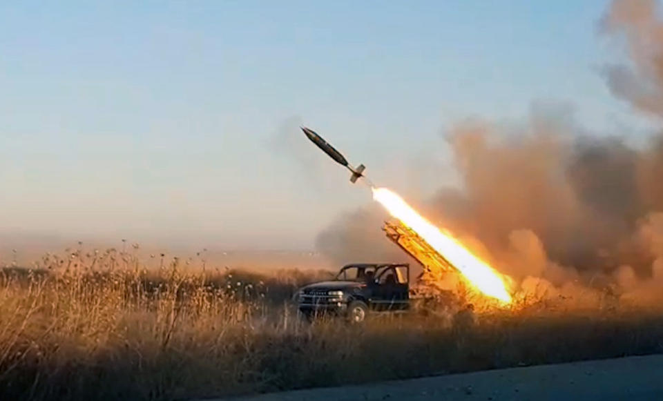 This photo provided by the Ibaa News Agency, the media arm of al-Qaida-linked Hayat Tahrir al-Sham militant group in Syria, purports to show a missile fired by the militant group against Syrian government forces position in Idlib province, Syria, Tuesday, Aug. 27, 2019. Ibaa said Hayat Tahrir al-Sham militant group fighters are attacking Syrian positions east of Khan Sheikhoun, a major town that was held by rebels until they lost it last week. (Ibaa News Agency via AP)