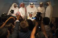 Saudi Energy Minister Prince Abdulaziz bin Salman speaks to journalists after a news conference that followed an OPEC meeting in Abu Dhabi, United Arab Emirates, Thursday, Sept. 12, 2019. OPEC's Joint Ministerial Monitoring Committee met Thursday in Abu Dhabi as estimates of lowered crude oil demand in 2020 have the cartel considering additional production cuts. Before the meeting started, Prince Abdulaziz again called for "cohesiveness" in OPEC. (AP Photo/Jon Gambrell)