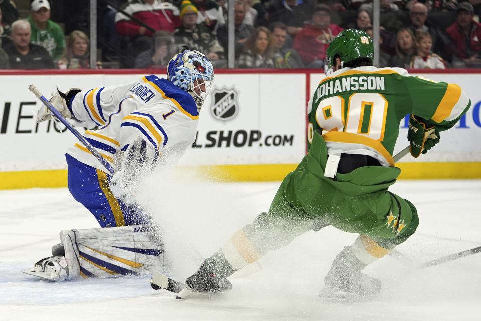 Buffalo Sabres goaltender Ukko-Pekka Luukkonen (1) defends against a shot attempt by Minnesota Wild left wing Marcus Johansson (90) during the first period of an NHL hockey game Saturday, Feb. 17, 2024, in St. Paul, Minn. (AP Photo/Abbie Parr)