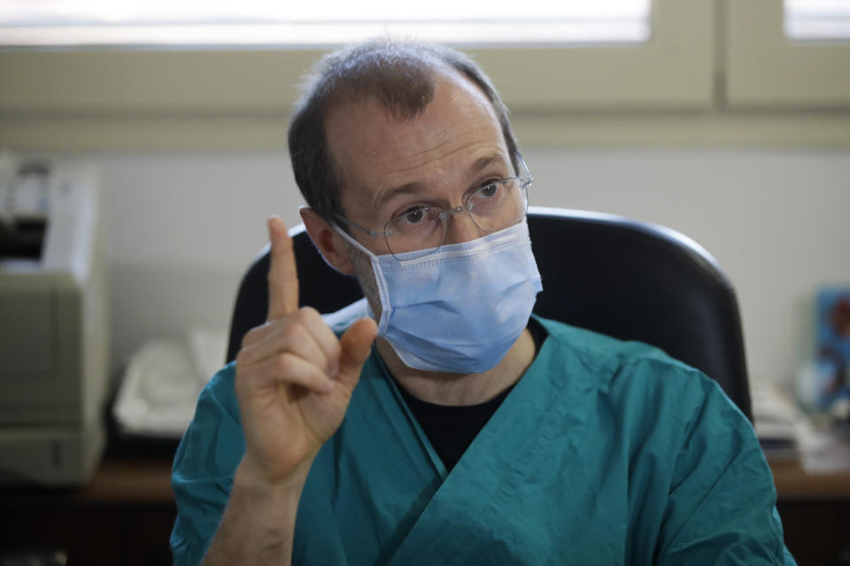 In this March 16, 2020, photo, Sergio Cattaneo, head of anesthesiology and intensive care at Brescia Ospedali Civili hospital, talks with The Associated Press about the coronavirus, in Brescia, Italy. "What is really shocking — something we had not been able to forecast and brought us to our knees — is the quickness the epidemic spreads,” Cattaneo said. "If the spreading of this epidemic is not put under control, it will bring all hospitals to their knees." (AP Photo/Luca Bruno)