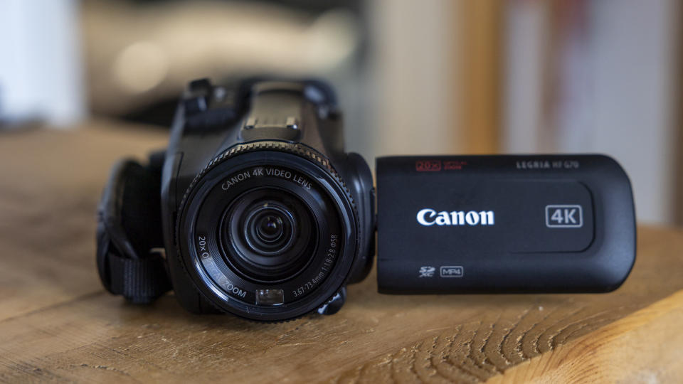 The Canon HF G70 on a wooden table with the screen tilted out