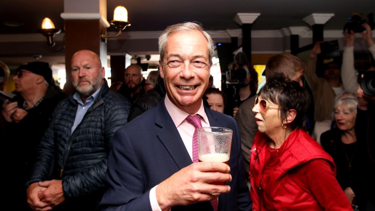  Nigel Farage holding a pint. 