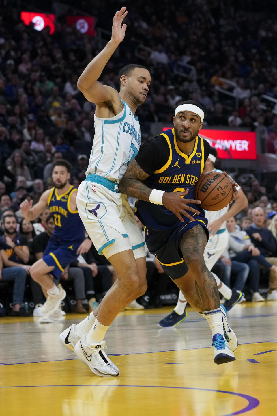 Golden State Warriors guard Gary Payton II drives against Charlotte Hornets guard Bryce McGowens during the first half of an NBA basketball game Friday, Feb. 23, 2024, in San Francisco. (AP Photo/Godofredo A. Vásquez)