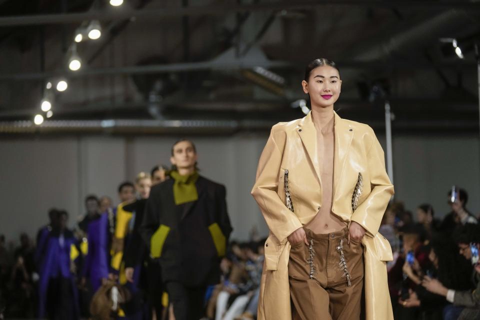Models wear creations as part of the Tokyo James women's Fall-Winter 2023-24 collection presented in Milan, Italy, Saturday, Feb. 25, 2023. (AP Photo/Antonio Calanni)