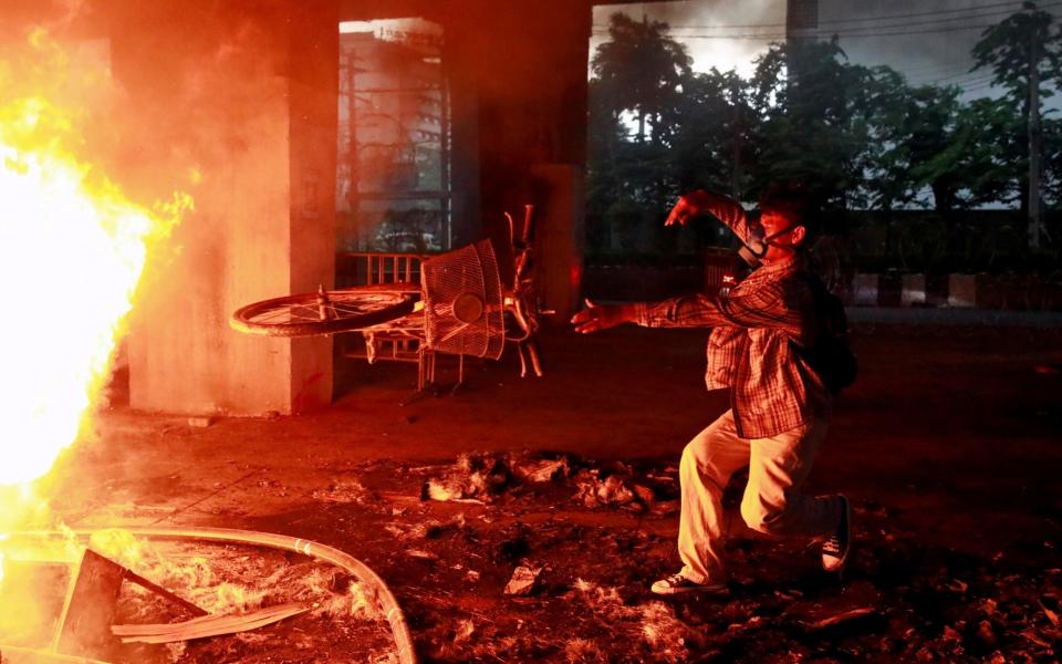 A demonstrator throws a bicycle into a fire during a protest against the Thai's government handling of the pandemic in Bangkok, Thailand on 13 August 2021 - Soe Zeya Tun/Reuters