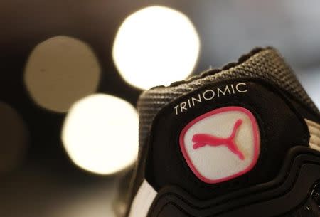 The logo of German sports goods firm Puma is seen on a shoe after the company's annual news conference in Herzogenaurach February 20, 2014. REUTERS/Michaela Rehle