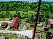 <p>The 2,000 acres of land is a mixture of derelict decomposition, rusting machinery, overturned offices and broken equipment. (Photo: Abandoned Southeast/Caters News) </p>